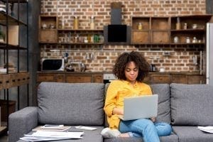 Woman watching virtual event.