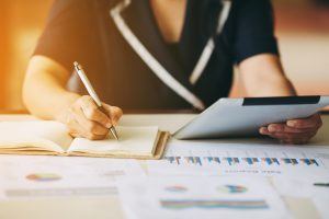 Woman doing accounting or calculating commission payments