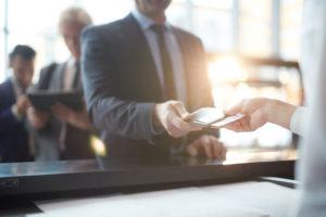 Businessman handing over airplane travel ticket